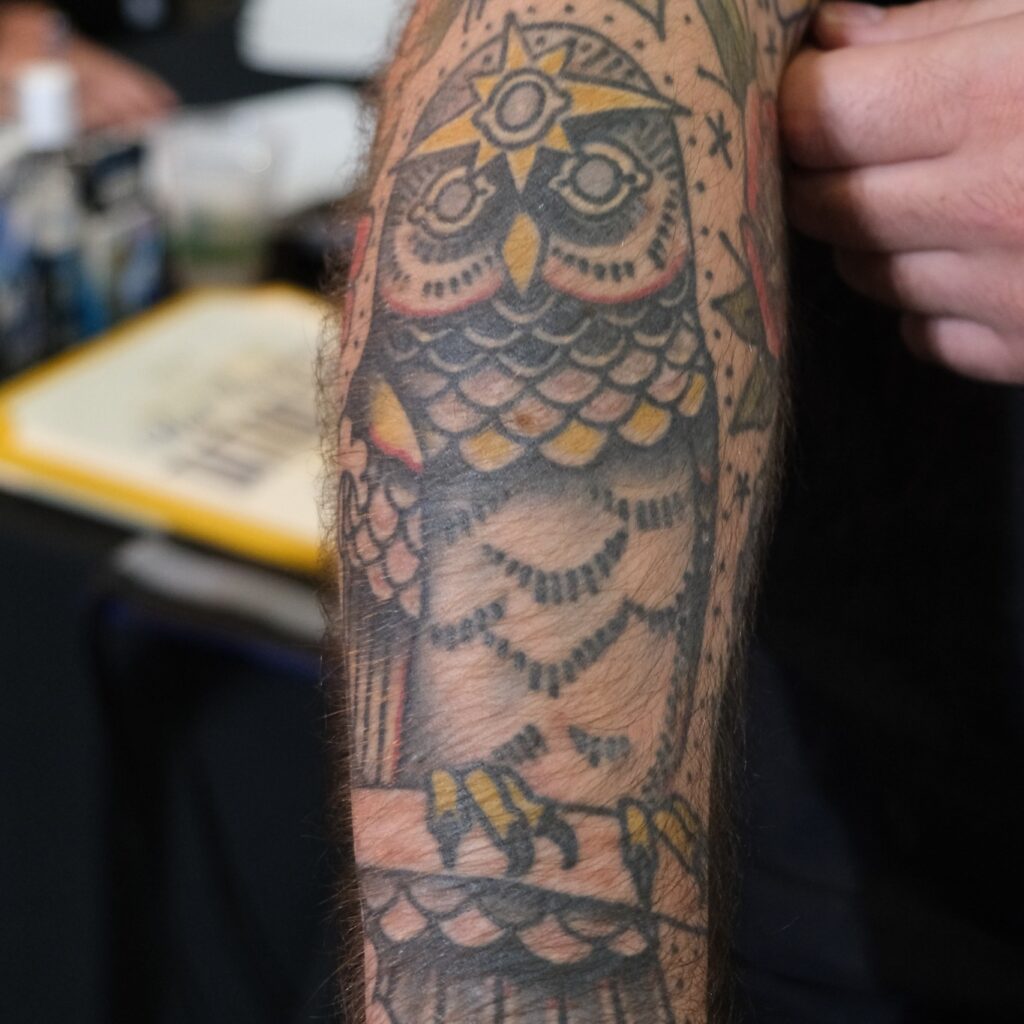 Tattoo of owl on a man's arm