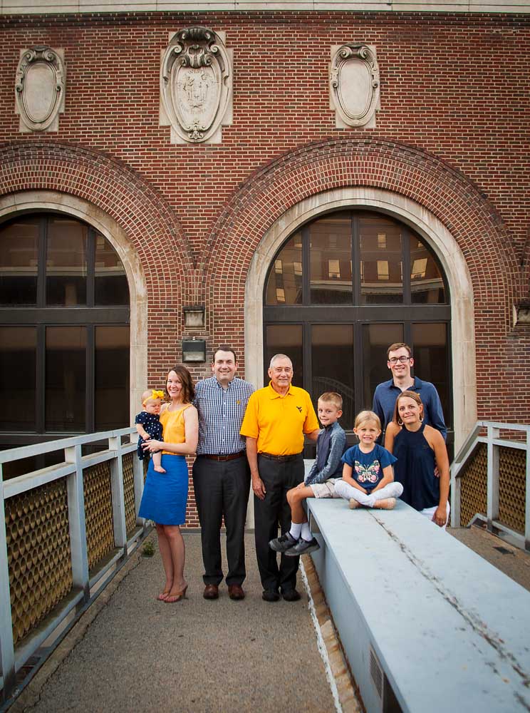Family stands in front of Stansbury hall in Morgantown